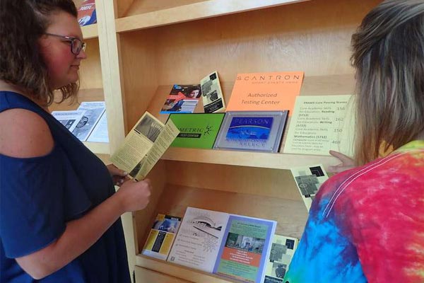 women browsing test booklets